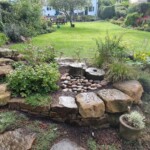 Modern garden design in Dundee with raised planters and stone pathway
